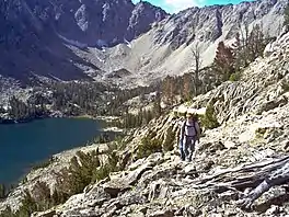 Hikers leaving Quiet Lake, which sits at the base of Castle Peak and Merriam Peak.