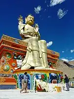 Hanging prayer flags on the 23&nbsp;m (75&nbsp;ft) statue of Maitreya