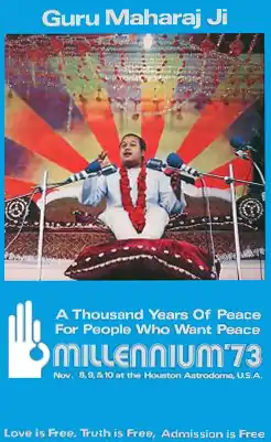 A blue poster featuring an image of an Indian youth with short hair, talking, sitting on a sofa, his feet on a cushion, several microphones in front of him. Below the picture, the poster has white letters spelling "A Thousand Years of Peace For People Who Want Peace", below that&nbsp;– in larger letters&nbsp;– "Millennium '73", and below that in smaller writing "Nov. 8, 9 & 10 at the Houston Astrodome U.S.A."