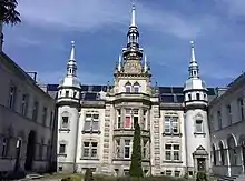 An image of the mansion taken from the inside of the courtyard showing the centre roof pinnacle
