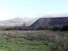 Slate tips on outer edges of Penrhyn Quarry at Mynydd Llandegai, the view looks out to Bethesda in the distance