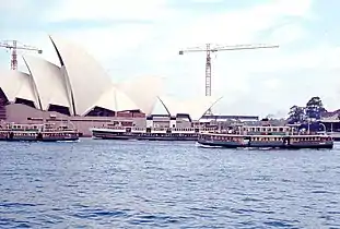 Lady Edeline, Manly ferry North Head, and Lady Ferguson in Sydney Cove with the Sydney Opera House under construction