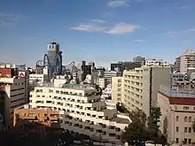 Buildings in Tokyo against a blue sky