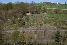 Black and white photo of a row of buildings with broken wood in front