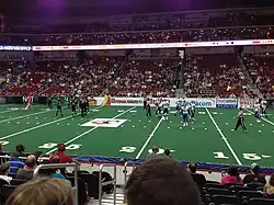 Players setting up on an arena football field